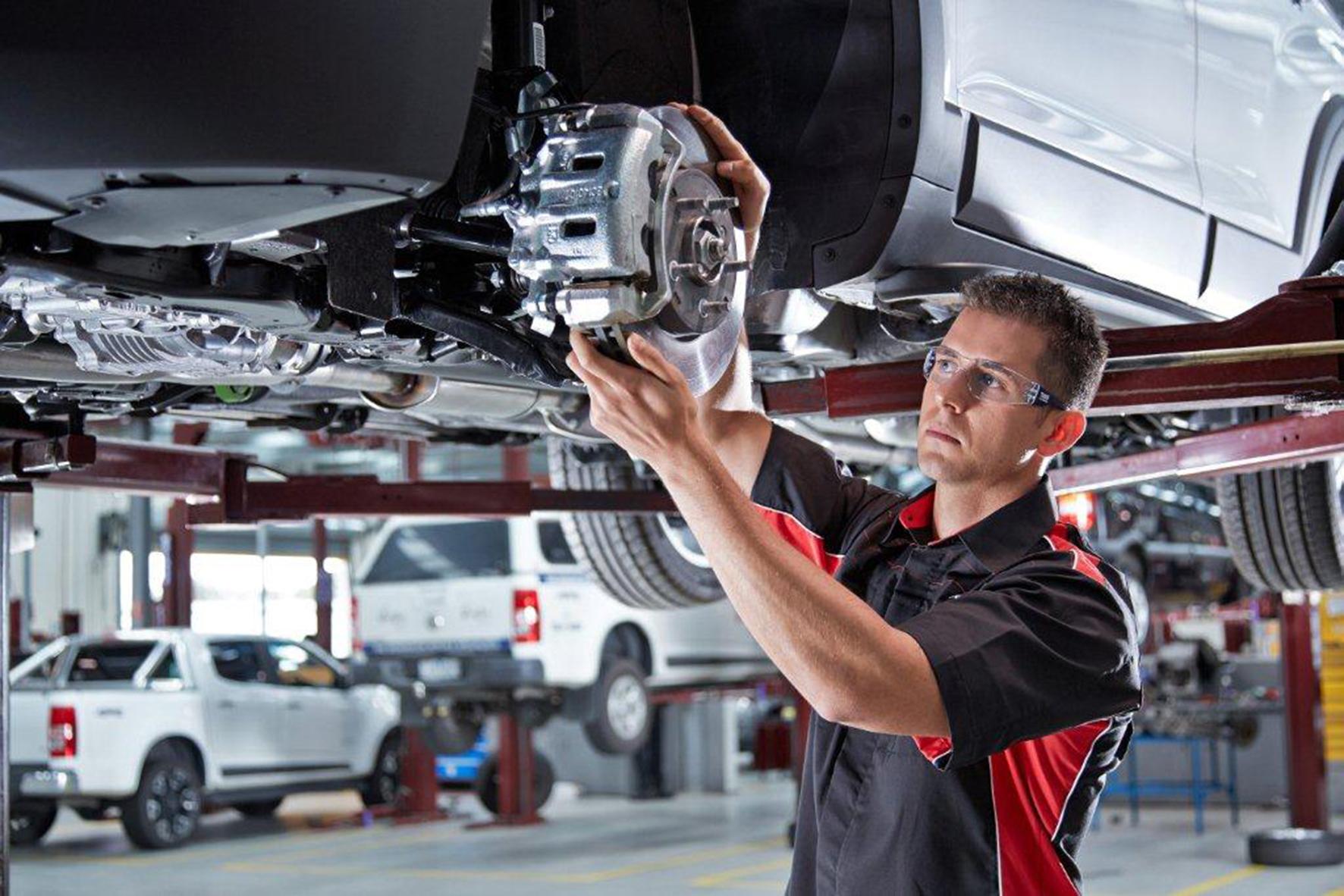 A workshop technician services a brake assembly, illustrating the aftermarket demand that underpins Bendix's business.