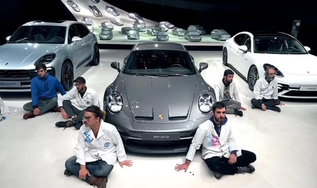 Genius activists glue themselves to Porsche museum floor, then