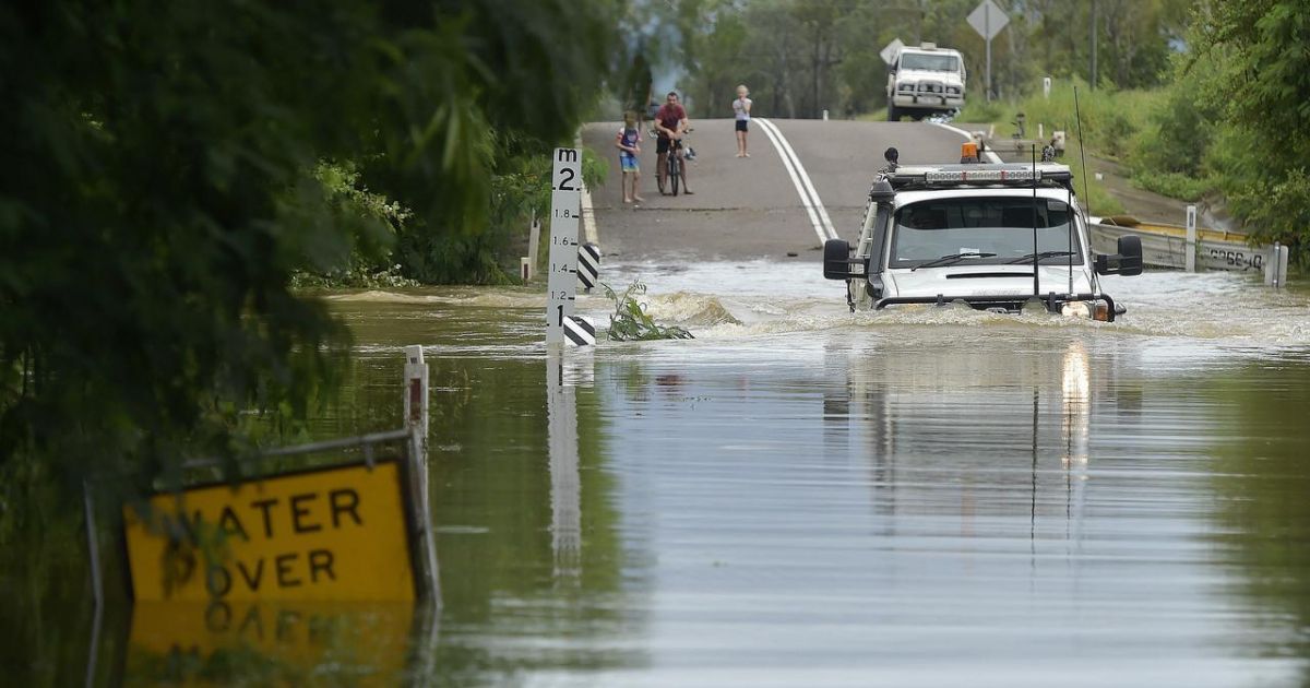 Is it unlawful to force in floodwaters or flooded roads?