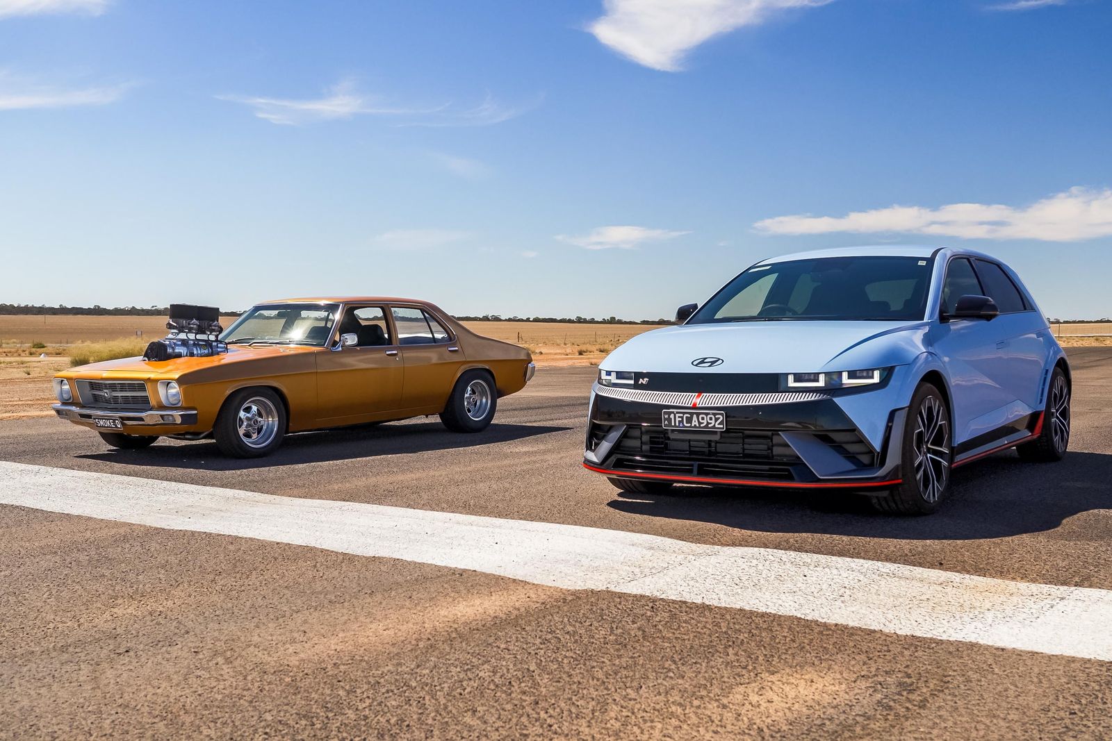1800hp blown Holden vs 650hp Hyundai EV drag race | CarExpert