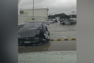 Out-of-control Tesla crashes into cars, plunges off carpark roof