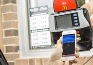 Is it illegal to use my phone to pay in the drive-thru or for parking?