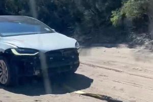 Rented Tesla Model X gets stuck on beach, front then ripped off car