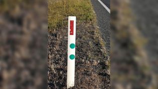 What do those green stickers on roadside posts mean?