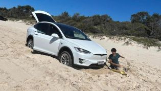 Rented Tesla Model X gets stuck on beach, front then ripped off car