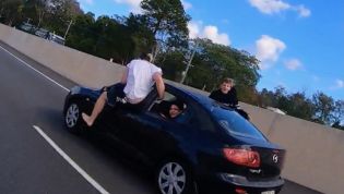 Wannabe stuntman tries air-walking out of moving car on Aussie highway