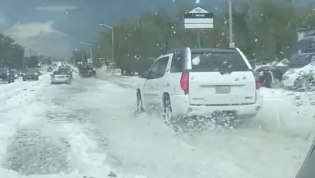 Take cover! Freak storm sees drivers negotiate 'rivers of hail'