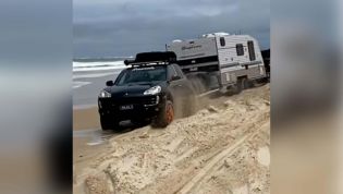 Porsche rescues big American pickup stuck on Aussie beach