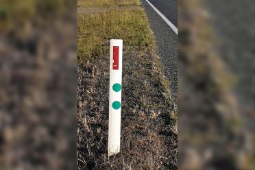 What do those green stickers on roadside posts mean?