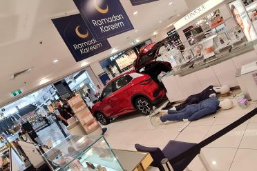Electric car displayed in shopping centre crashes into store, two hospitalised
