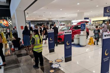Electric car displayed in shopping centre crashes into store, two hospitalised