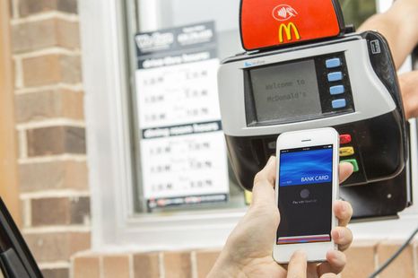 Is it illegal to use my phone to pay in the drive-thru or for parking?