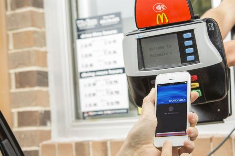 Is it illegal to use my phone to pay in the drive-thru or for parking?