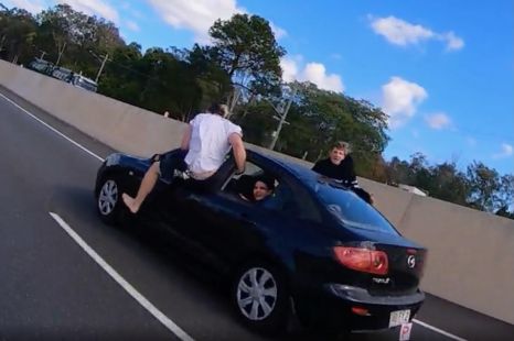 Wannabe stuntman tries air-walking out of moving car on Aussie highway
