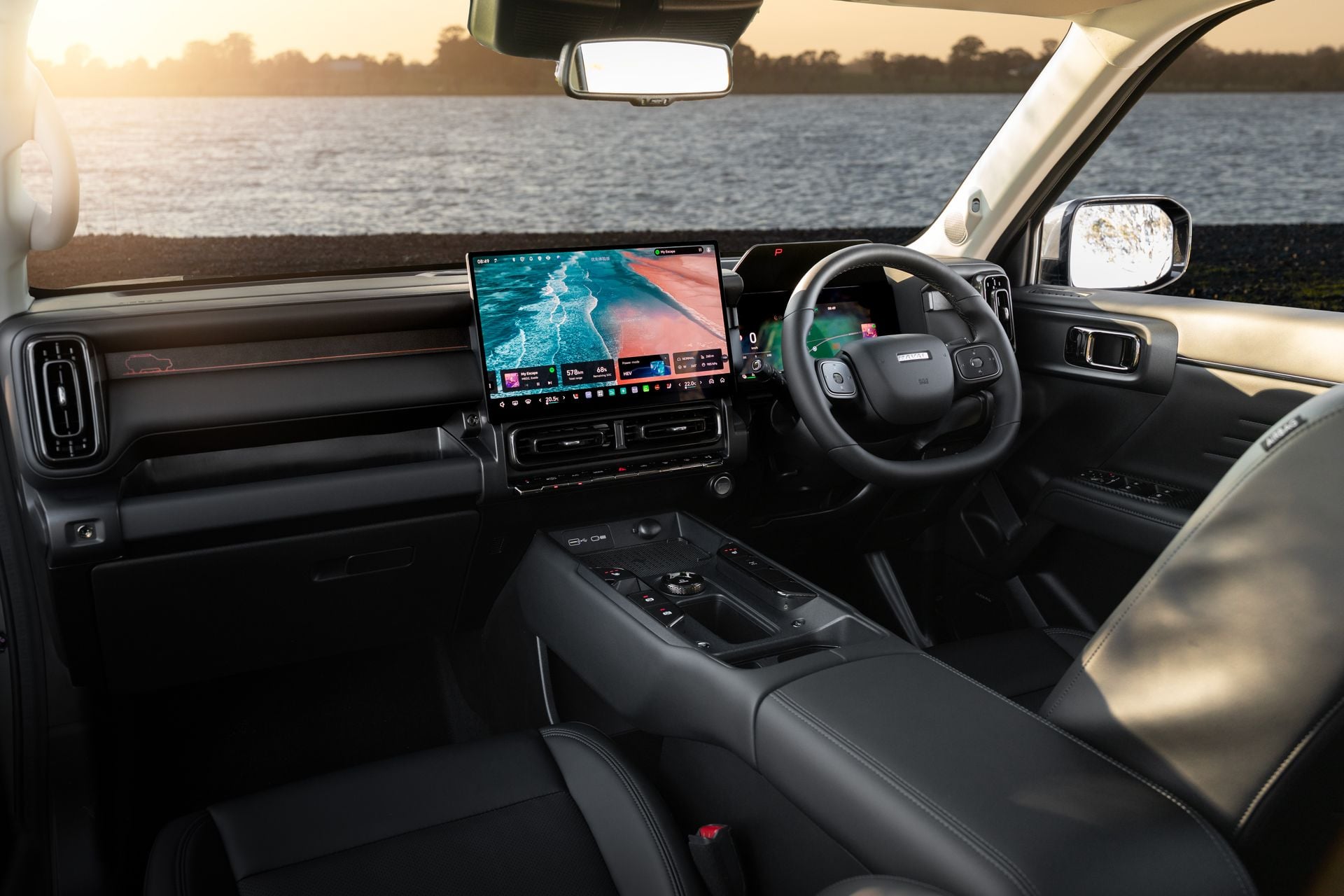 Interior of a GWM Haval H7 showing the large central touchscreen infotainment display, digital instrument cluster, steering wheel, and centre console with dark leather upholstery