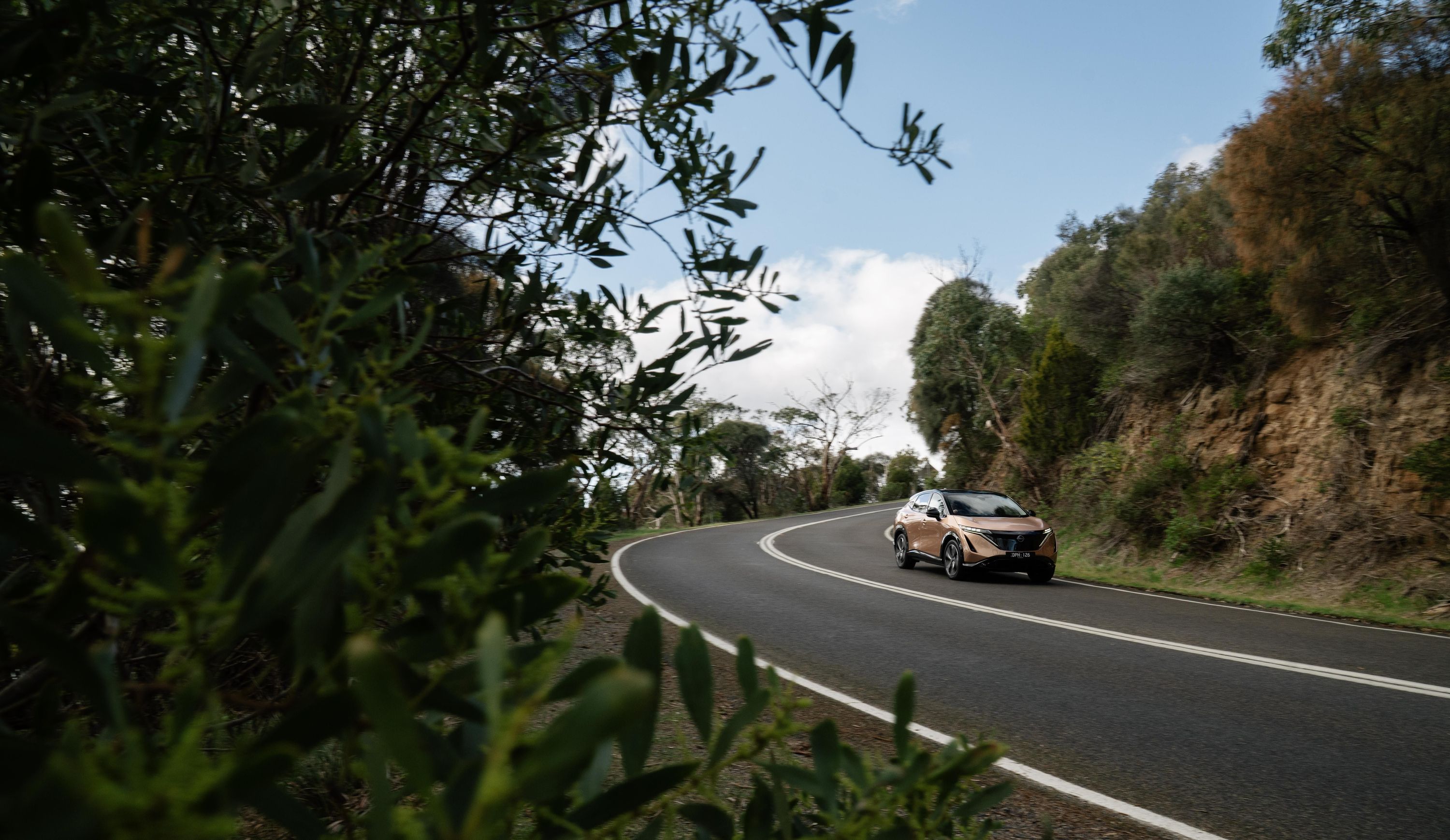 2025 Nissan ARIYA Evolve+ in golden exterior color at Jackie Cooper Nissan Tulsa showroom