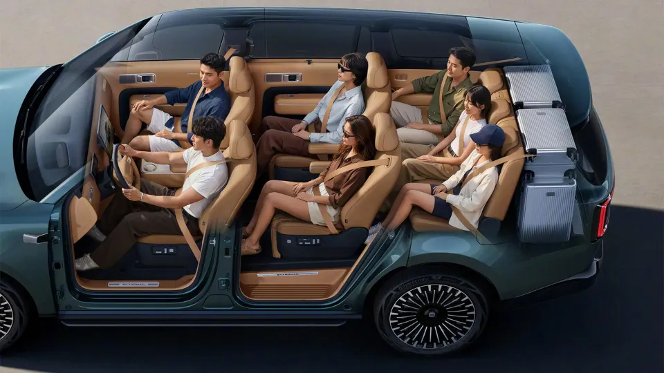 A cutaway-style promotional image of the Xiaomi Skynomad N90 minivan showing six passengers seated across three rows of tan leather seats, with luggage visible in the rear cargo area