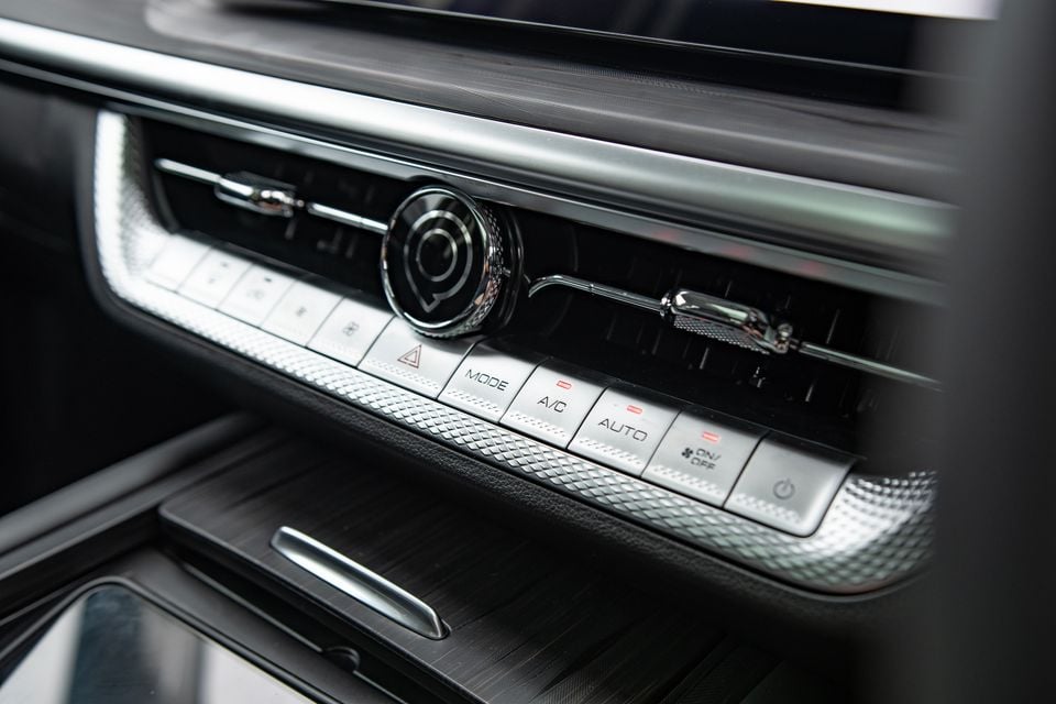 Close-up of the climate control buttons and central air vent on the dashboard of a 2026 GWM Cannon Alpha Vanta