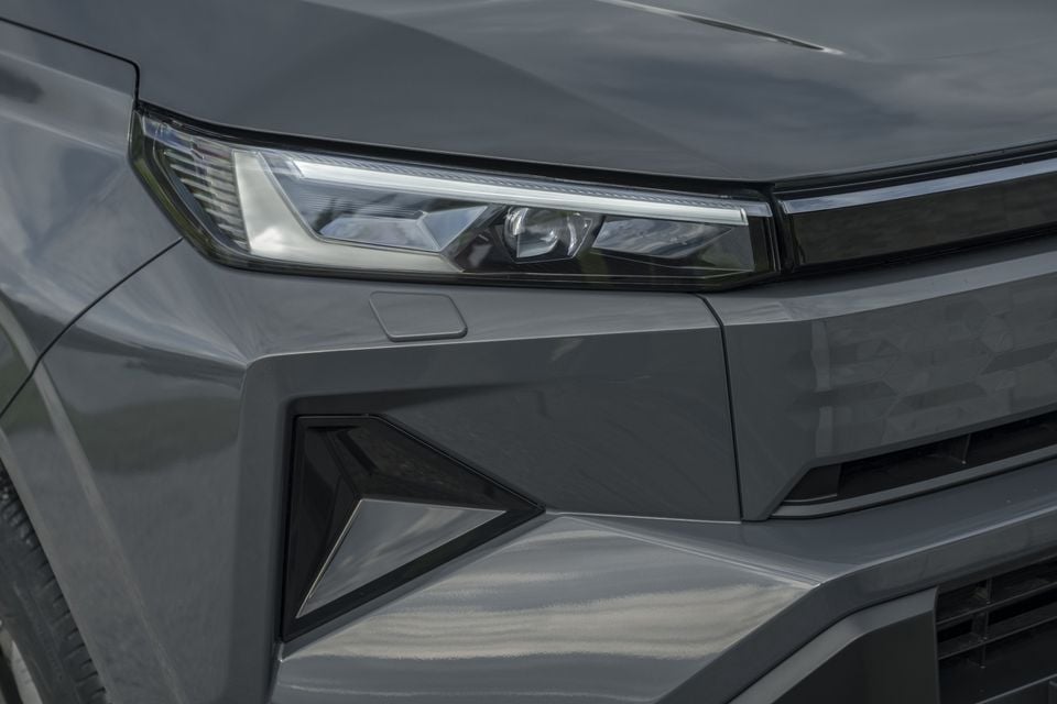 Close-up of the headlight and front bumper detail on a grey 2026 Toyota HiLux BEV