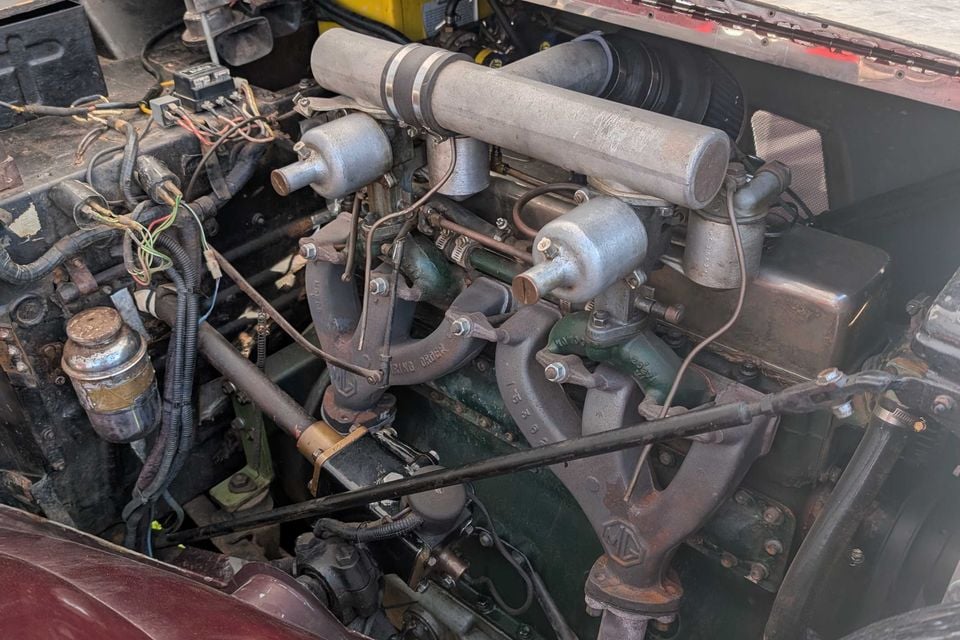 The inline six-cylinder engine of a 1936 MG SA saloon, showing twin SU carburettors and MG-branded exhaust manifolds under the open bonnet