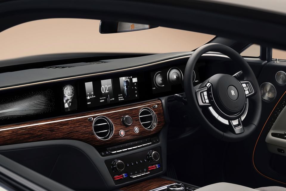 Dashboard of the 2027 Rolls-Royce Spectre with steering wheel, digital displays, wood veneer trim and climate controls