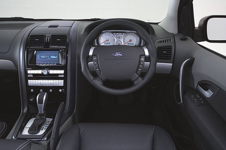 The interior of a 2006 Ford Territory Turbo Ghia, showing the steering wheel, instrument cluster and dashboard controls.