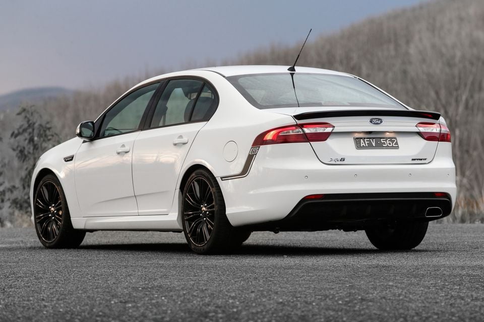 A white 2016 Ford Falcon XR6 Sprint sedan photographed from the rear quarter on a road