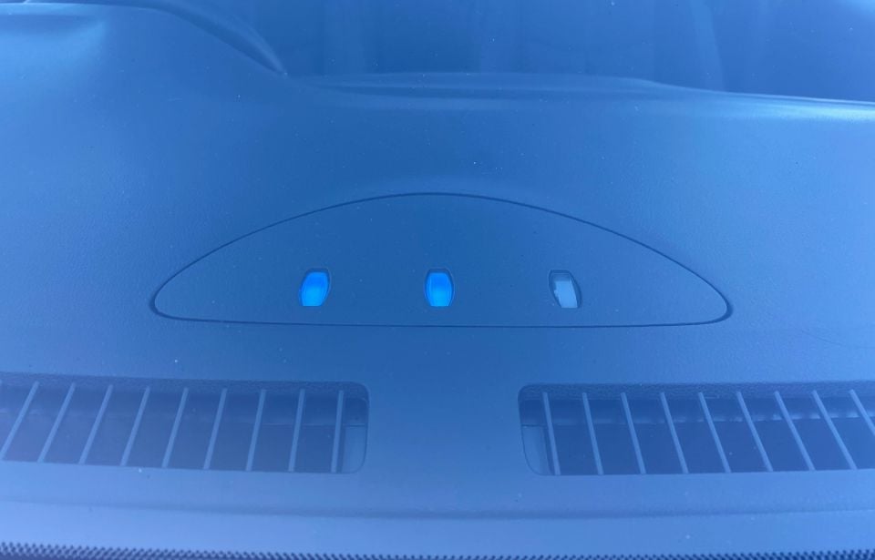 Three charging progress indicators visible from outside the car