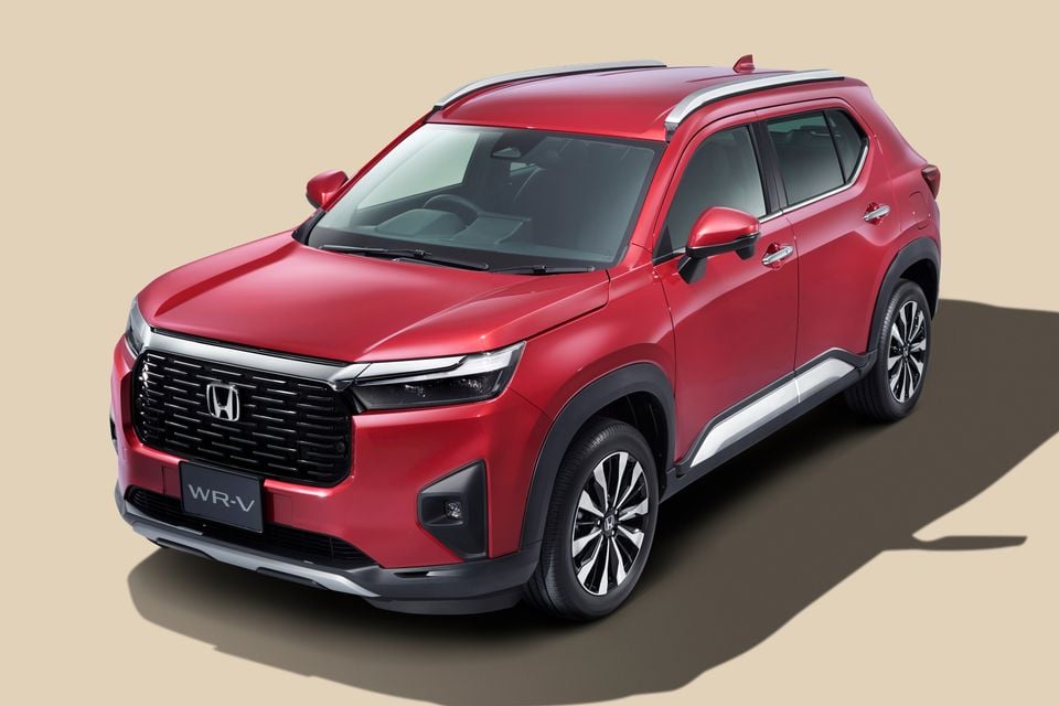 A red 2024 Honda WR-V SUV seen from the front three-quarter angle against a neutral studio background.