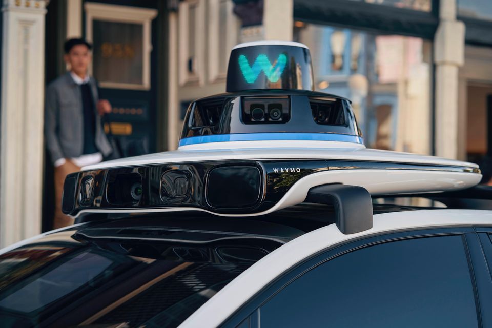 Close-up of the roof-mounted Waymo sensor equipment on a Jaguar I-Pace in an existing overseas press photograph.