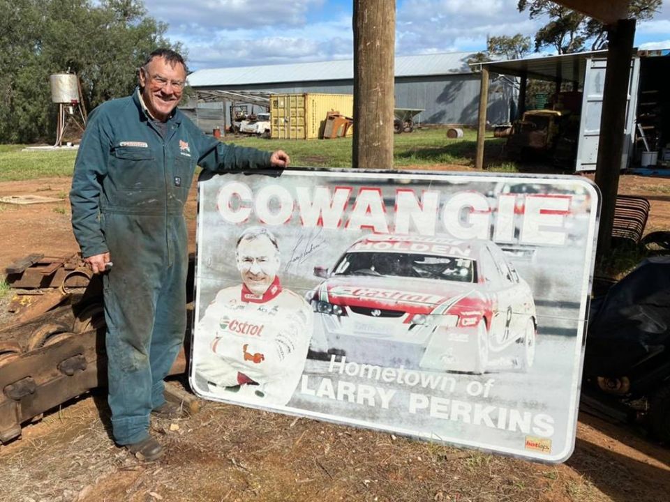 A weathered sign autographed by Larry Perkins before being auctioned off in 2020