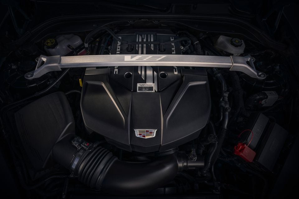 The supercharged 6.2-litre V8 engine bay of the 2025 Cadillac CT5-V Blackwing, with a V-Series strut brace and Cadillac crest on the engine cover