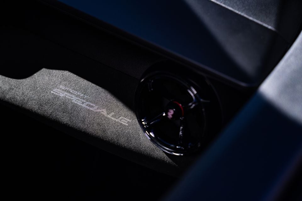 Close-up of the Alcantara-trimmed centre console area in the 2026 Alfa Romeo Junior Sport Speciale, showing a rotary control and embroidered branding