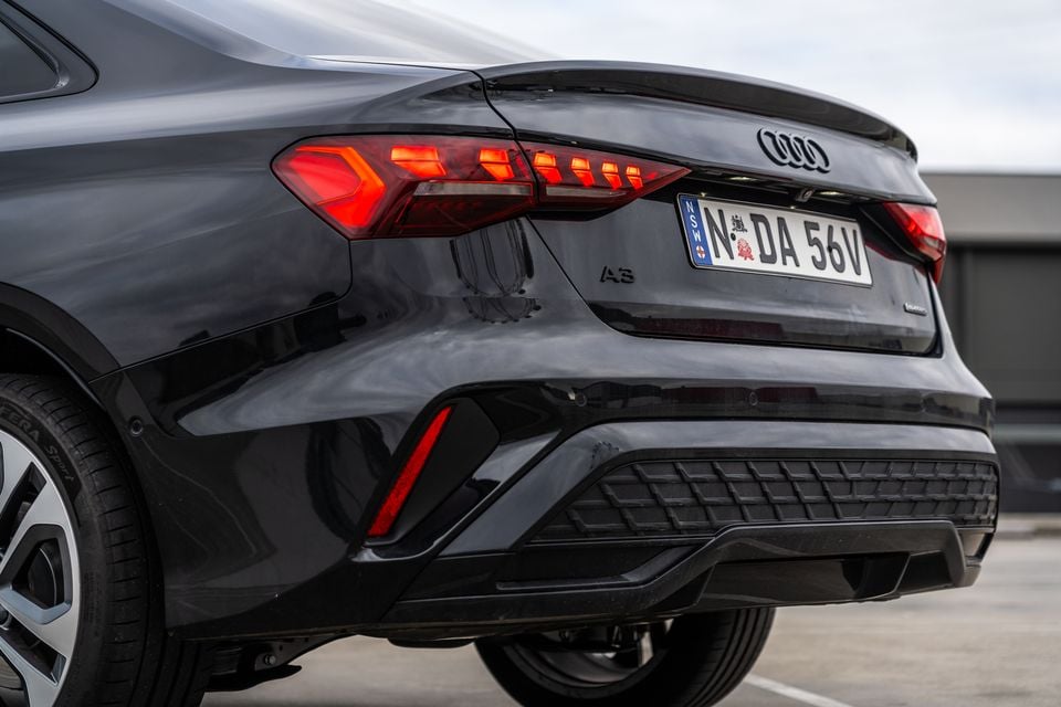 Rear of a dark grey 2026 Audi A3 sedan showing LED tail lights, A3 badge, and NSW number plate