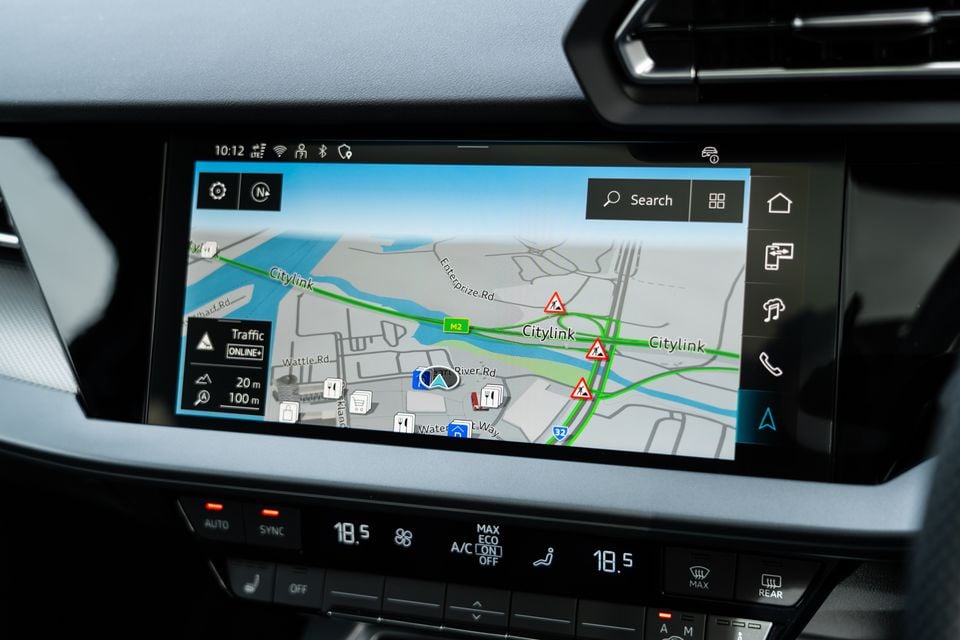 The infotainment touchscreen of a 2026 Audi A3 displaying built-in navigation with Melbourne's Citylink freeway, alongside climate control panel below