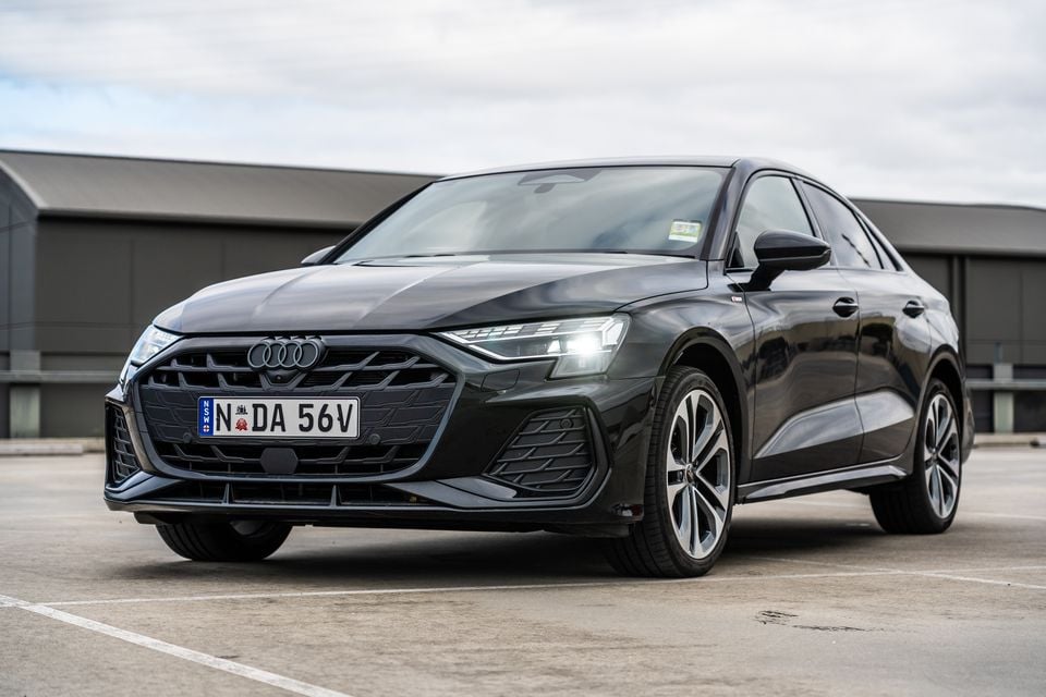 A dark grey 2026 Audi A3 sedan seen from the front three-quarter angle in a car park