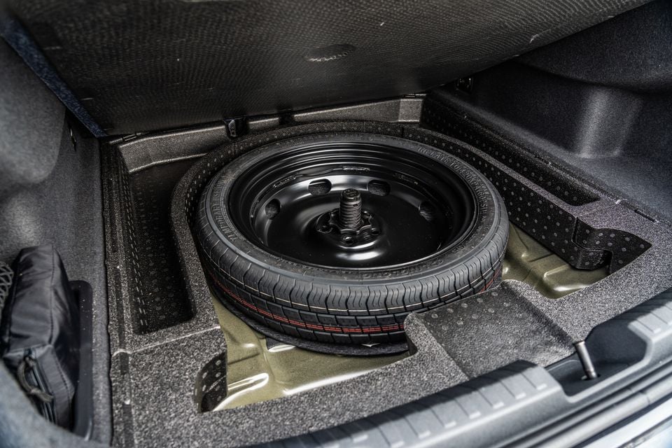 A space-saver spare tyre stored under the boot floor of a 2026 Audi A3 sedan