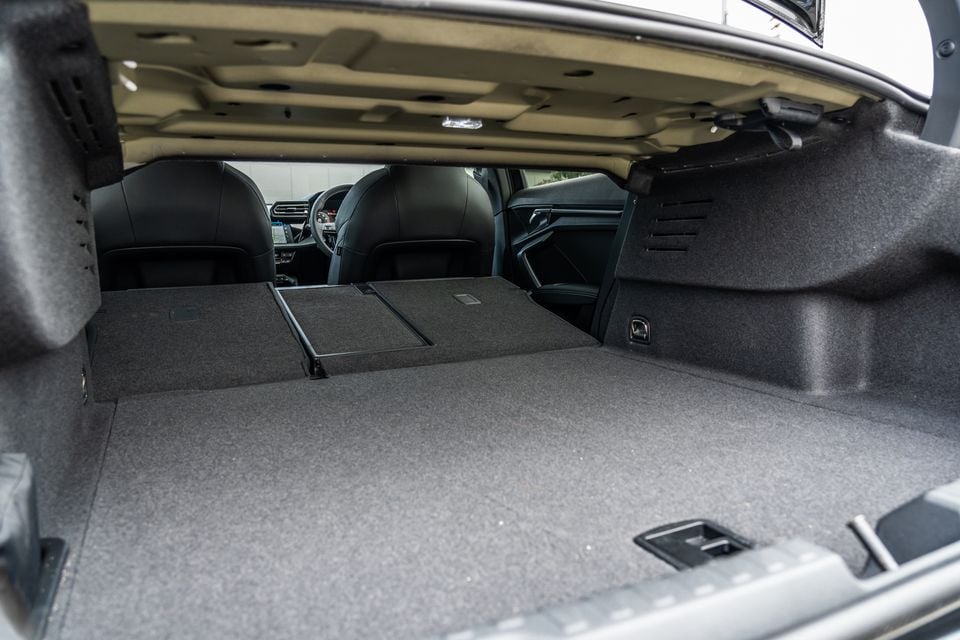 Boot space of a 2026 Audi A3 sedan with rear seats folded flat, expanding the cargo area