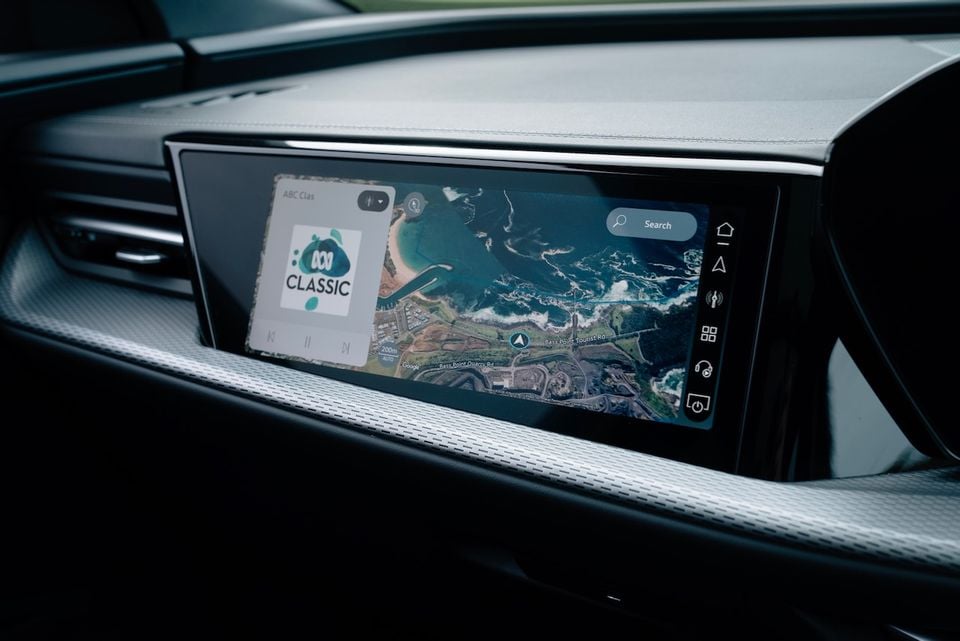 The infotainment touchscreen of a 2026 Audi Q5 e hybrid Sportback showing Google Maps navigation and ABC Classic radio playing