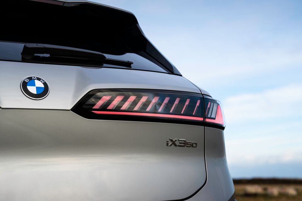 Close-up of the rear of a BMW iX3 50 showing the LED tail light and iX350 badge on a silver SUV