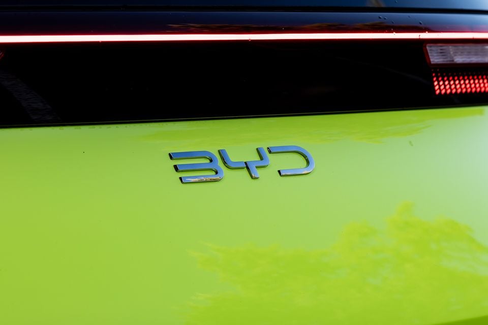 Close-up of the BYD badge on the rear of a lime green BYD Atto 1