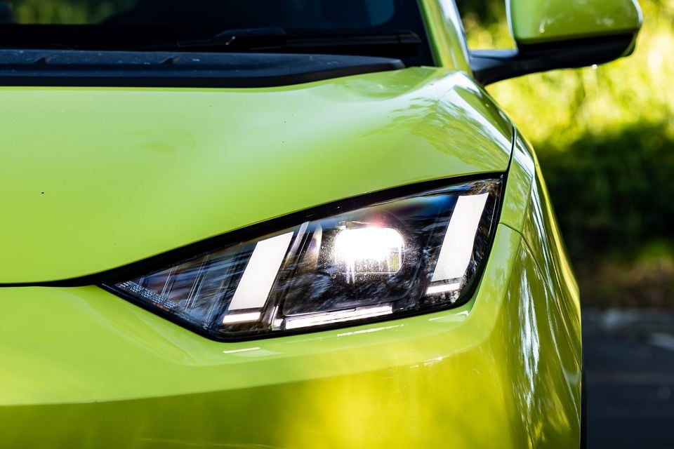 Close-up of the LED headlight on a lime green 2026 BYD Atto 1