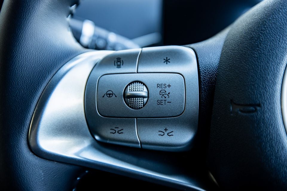 Close-up of the steering wheel controls on a BYD Atto 1, showing cruise control and driver assistance buttons
