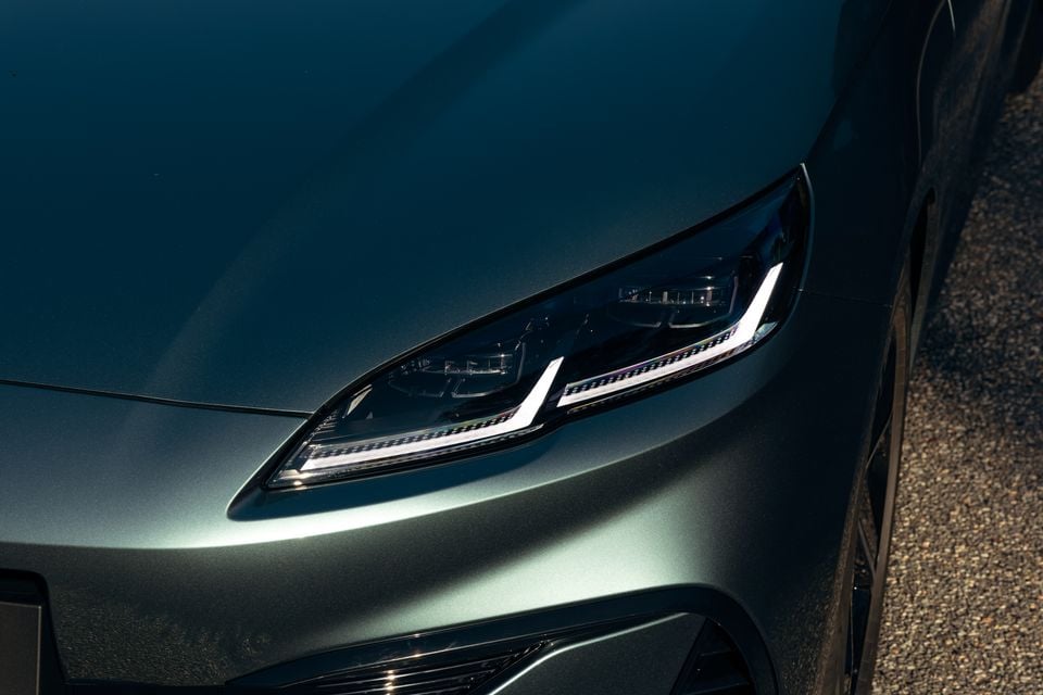 Close-up of the LED headlight on a green 2026 BYD Seal 6 Touring