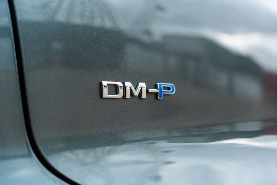 Close-up of the DM-P badge on the body of a BYD Sealion 8, indicating its plug-in hybrid variant