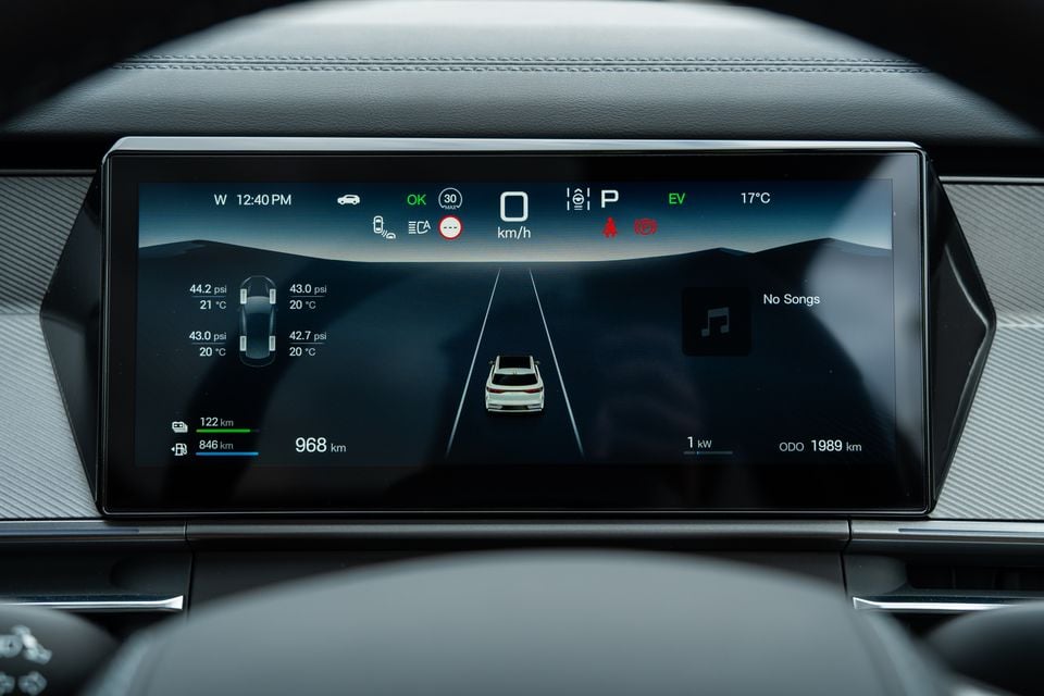 The digital instrument cluster of a 2026 BYD Sealion 8, showing tyre pressure readings, EV range of 968 km, odometer at 1989 km, and a bird's-eye vehicle graphic on a dark display.