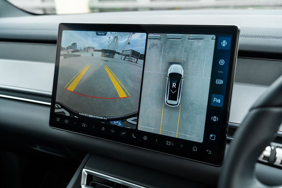 The touchscreen infotainment display in a 2026 BYD Sealion 8 showing the reverse camera view with parking guidelines alongside a 360-degree surround view camera display.