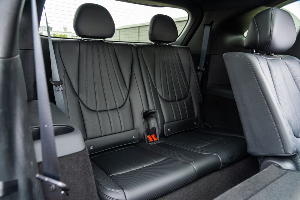 Black leather rear seats of a 2026 BYD Sealion 8, showing two headrests, seatbelts, and stitched upholstery detail
