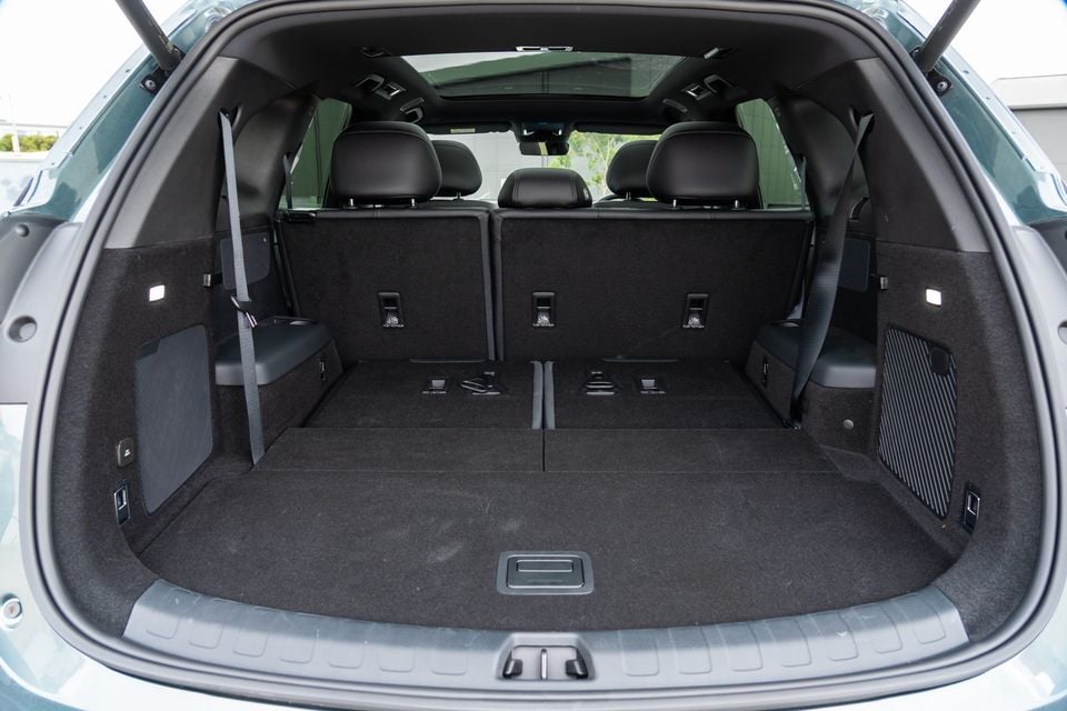 The empty boot of a 2026 BYD Sealion 8 SUV, showing a large carpeted cargo area with the rear seats up and top-tether anchor points visible