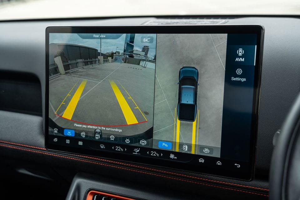 The 2026 BYD Shark 6 touchscreen showing the rear-view camera with parking guidelines alongside an overhead 360-degree view of the ute